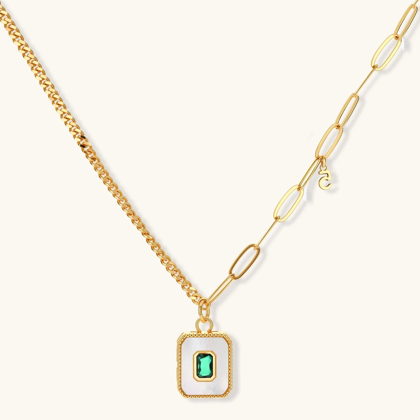 Gold-plated jewelry set with white enamel square pendants and emerald CZ stones on cream background.