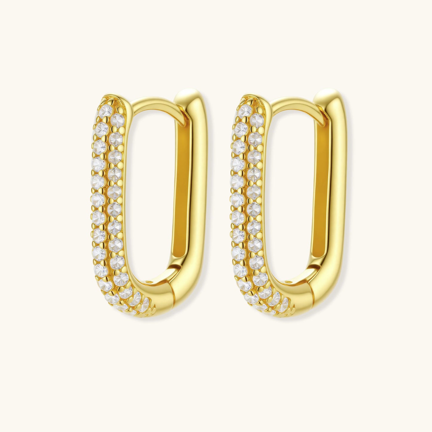 Close-up of small sterling silver huggie hoops completely covered in sparkling clear crystals with hinged closure