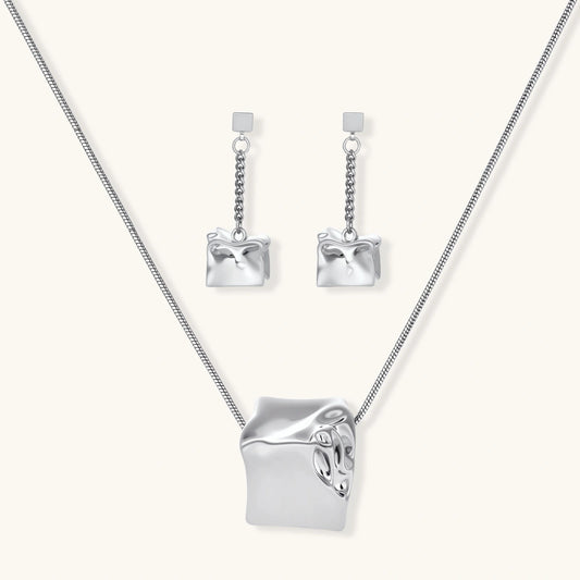 Geometric jewelry set with textured cube pendants on chains, featuring eco-zinc alloy in silver and gold finishes.
