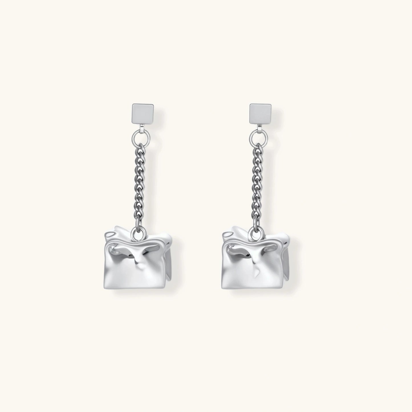 Geometric jewelry set with textured cube pendants on chains, featuring eco-zinc alloy in silver and gold finishes.