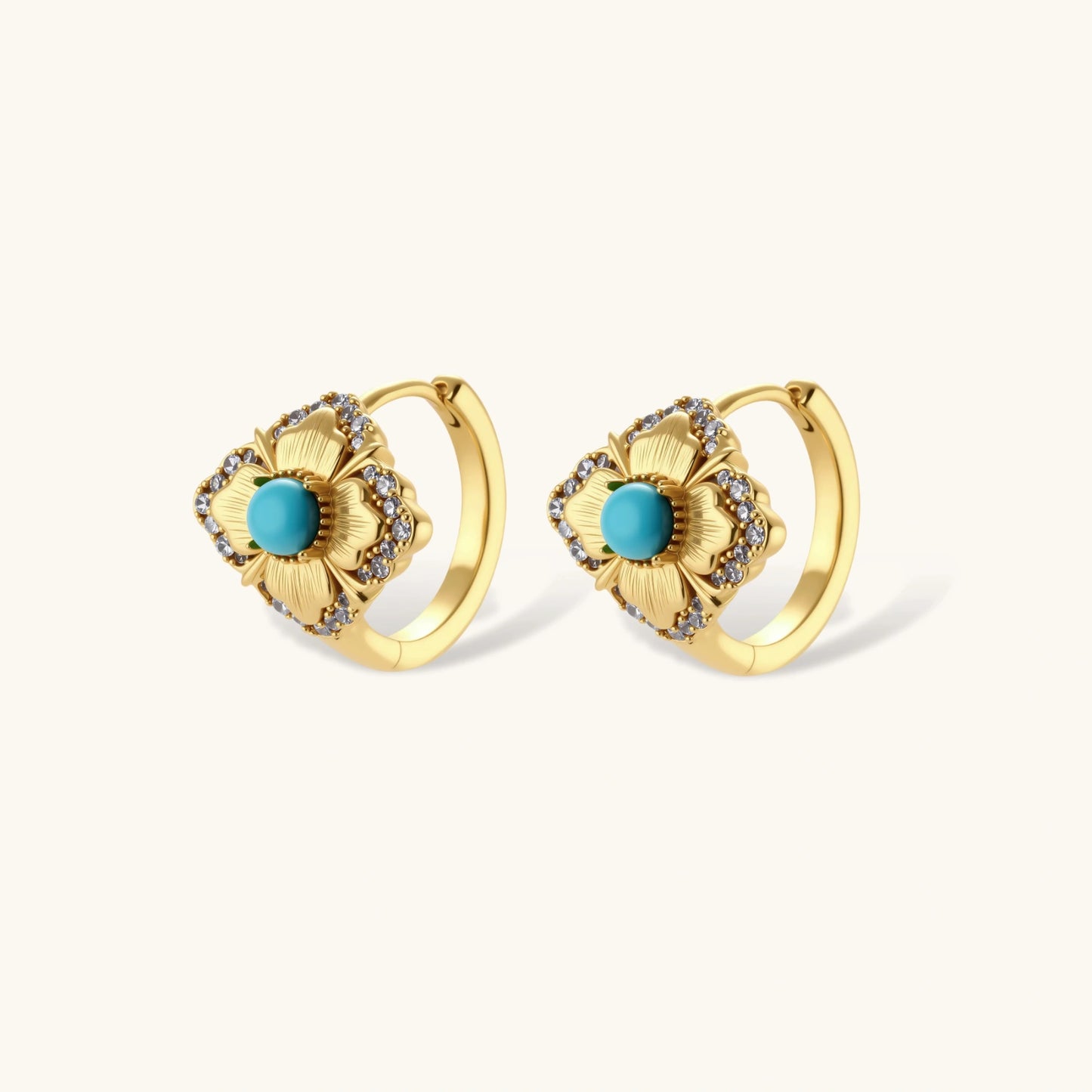 Close-up of 18K gold plated hoop earrings with turquoise center stones and zircon crystals in quatrefoil flower design