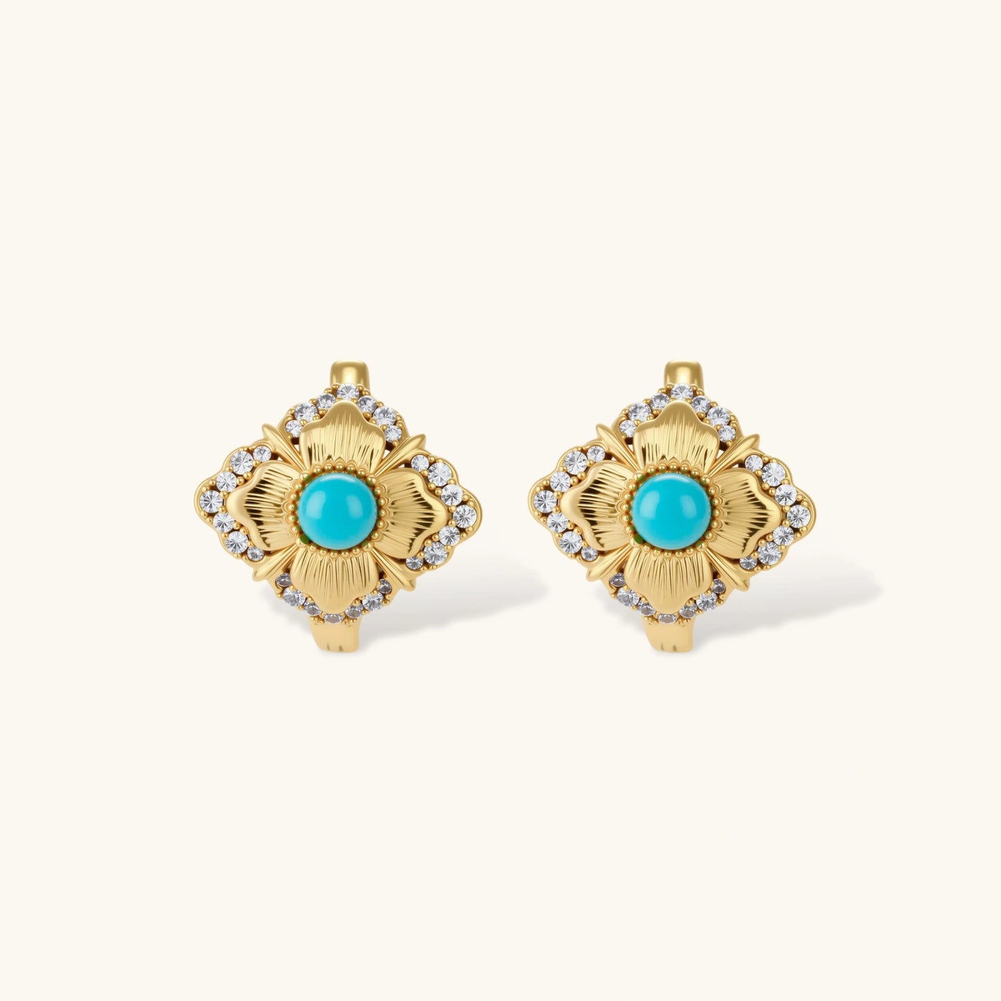 Close-up of 18K gold plated hoop earrings with turquoise center stones and zircon crystals in quatrefoil flower design